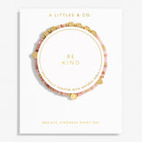 A Littles & Co. Bracelet with 'Be Kind' message on a white background, featuring gold and pink beads. Available at Be Charmed