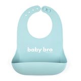 Bella Tunno Baby Bro Wonder Bib in soft blue, featuring a "baby bro" design, adjustable neck, and a catch pocket, made from BPA-free silicone, available at Be Charmed