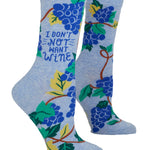Blue socks with grapevine design and text 'I Don't Not Want Wine' on a white background. Available at Be Charmed