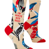 Colorful socks with bird designs and text on a beige background. Available at Be Charmed