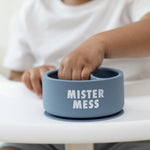 Child using a Bella Tunno Mister Mess Wonder Bowl in blue, featuring a suction base and curved lip, available at Be Charmed.