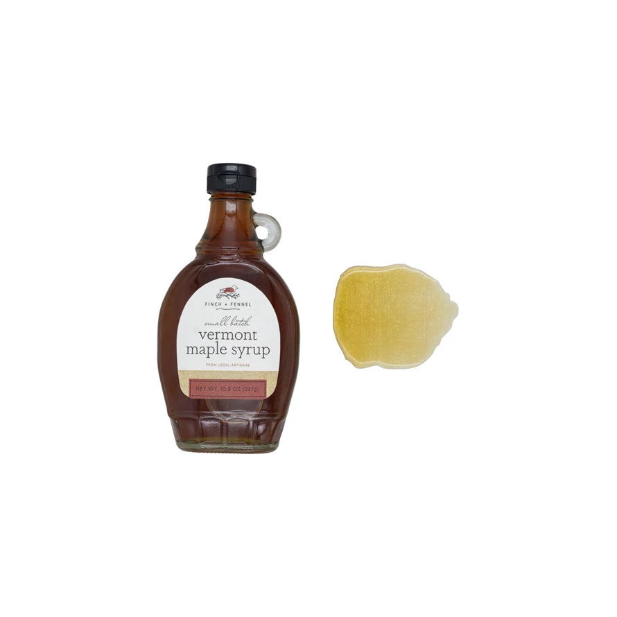 Bottle of Vermont maple syrup with a sample on a white background. Available at Be Charmed