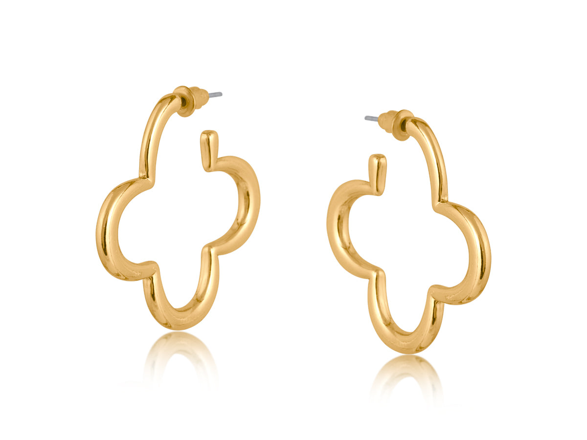 Gold Big Metal London Carmen earrings: 3.5 cm clover‑shaped floral metal hoops in radiant gold or sleek silver plating, hypoallergenic surgical steel posts, made with 50% recycled brass. Lightweight, sustainable fashion at its finest. Available at Be Charmed
