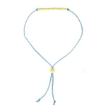 Lucky Feather Sweet Sixteen Milestone Birthday Bracelet featuring 16 gold-dipped beads on an adjustable cord, symbolizing each year. Available at Be Charmed.