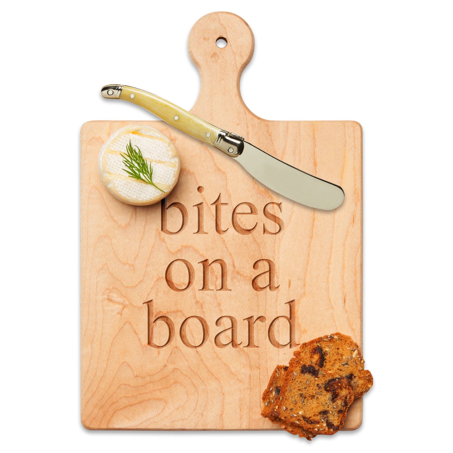 Wooden cutting board with 'bites on a board' engraving, knife, and food items on a white background