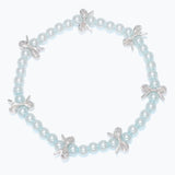 Kids bracelet with light blue pearls and silver bow charms on a white background. Available at Be Charmed.