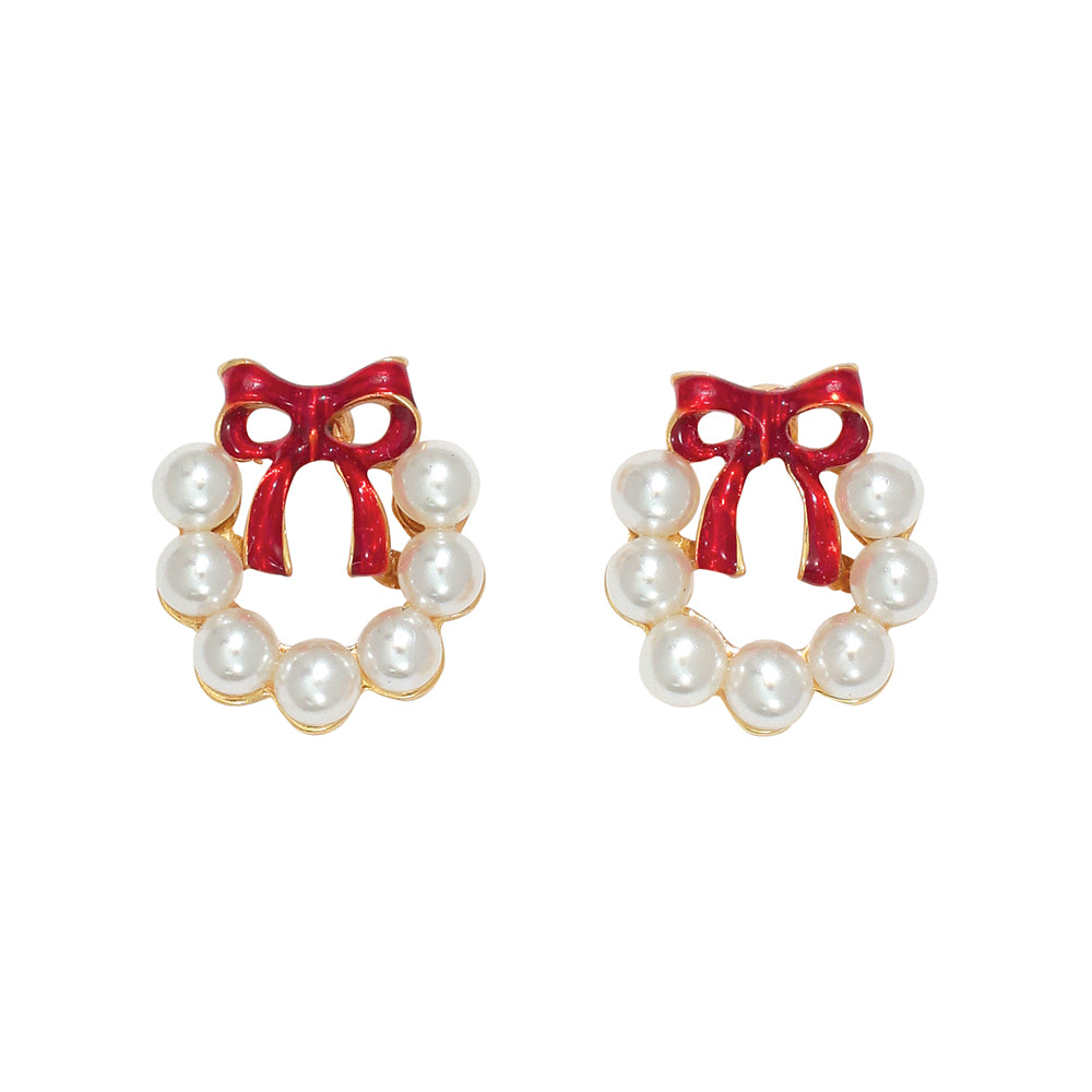 Pair of wreath earrings with red bows and pearl-like centers on a white background. Available at Be Charmed.