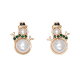 Pair of earrings with pearl-like centers and gold and green accents on a white background. Available at Be Charmed.