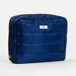 Navy Puffer Scout All Inclusive Travel Organizer – lightweight quilted toiletry bag with multiple compartments and zipper closures. Folds flat for easy packing. Available at Be Charmed.