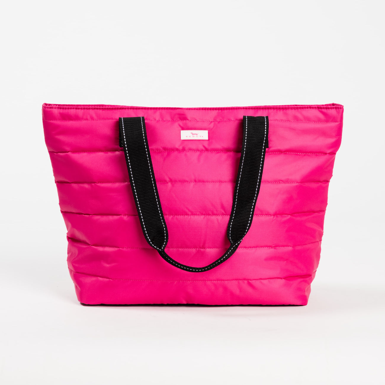 Pink Puffer SCOUT Layover Tote – quilted puffer travel tote (19″ W × 13″ H × 5.5″ D), interior zipper compartments, reinforced bottom, folds flat. Available at Be Charmed
