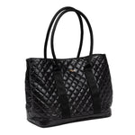 Scout Miss Manors Black quilted handbag with gold logo on a white background. Available at Be Charmed