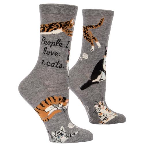 Gray socks with cat illustrations and text on a white background. Available at Be Charmed
