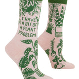 Pink socks with green plant designs and text on a white background. Available at Be Charmed