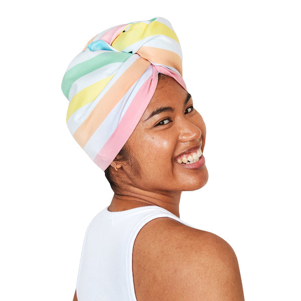 Woman wearing a Dock & Bay Unicorn Waves Hair Wrap – Quick-dry, lightweight towel in various colors, designed for efficient hair drying, available at Be Charmed.