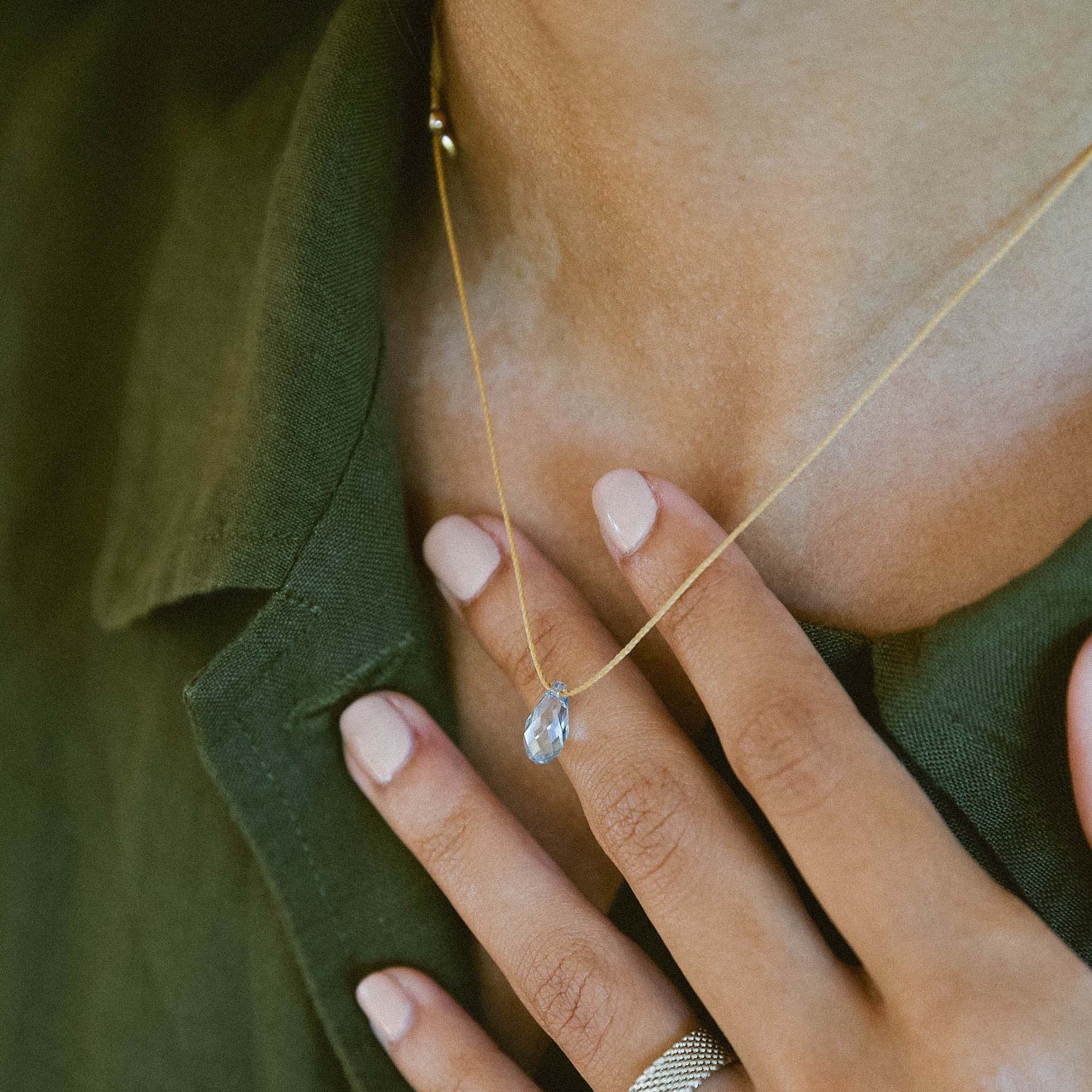 Woman wearing &LIVY Hyevibe Crystal Slider Necklace Blue Shade on Gold