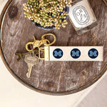 Rustic Marlin M Logo Medfield MA Keychain pictured on wooden tray