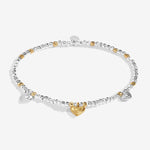 An A Littles Bracelet with heart-shaped charms on a white background. Available at Be Charmed