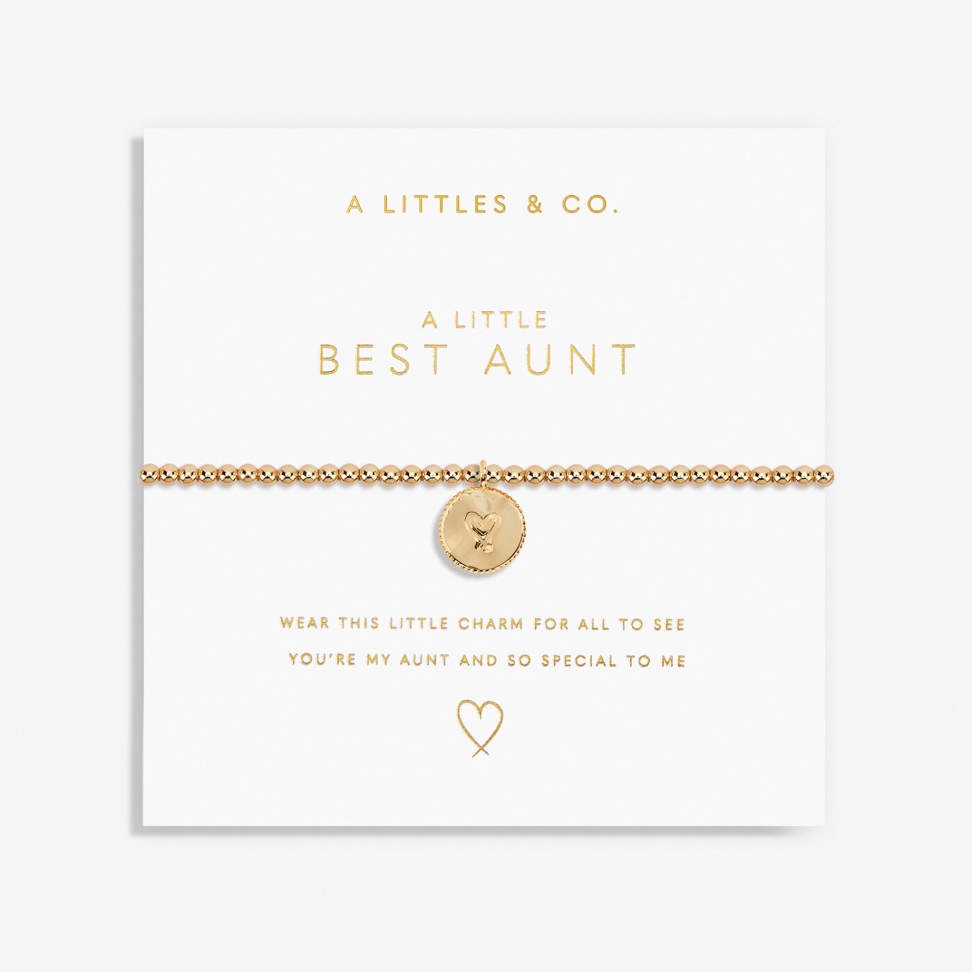 Gold bracelet with heart charm on a white card with 'A Littles & Co.' text. Available at Be Charmed