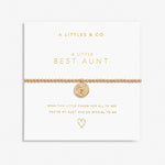 Gold bracelet with heart charm on a white card with 'A Littles & Co.' text. Available at Be Charmed