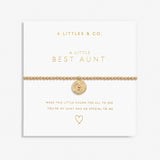 Gold bracelet with heart charm on a white card with 'A Littles & Co.' text. Available at Be Charmed