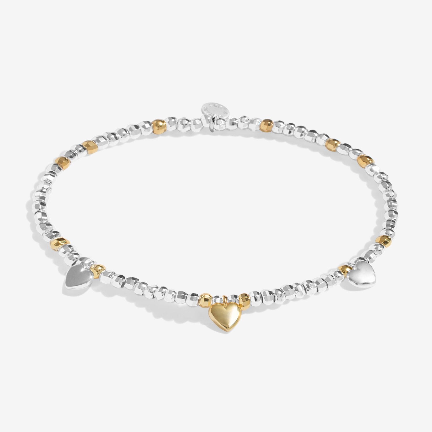 Bracelet with heart charm and clear stones on a white background. Available at Be Charmed