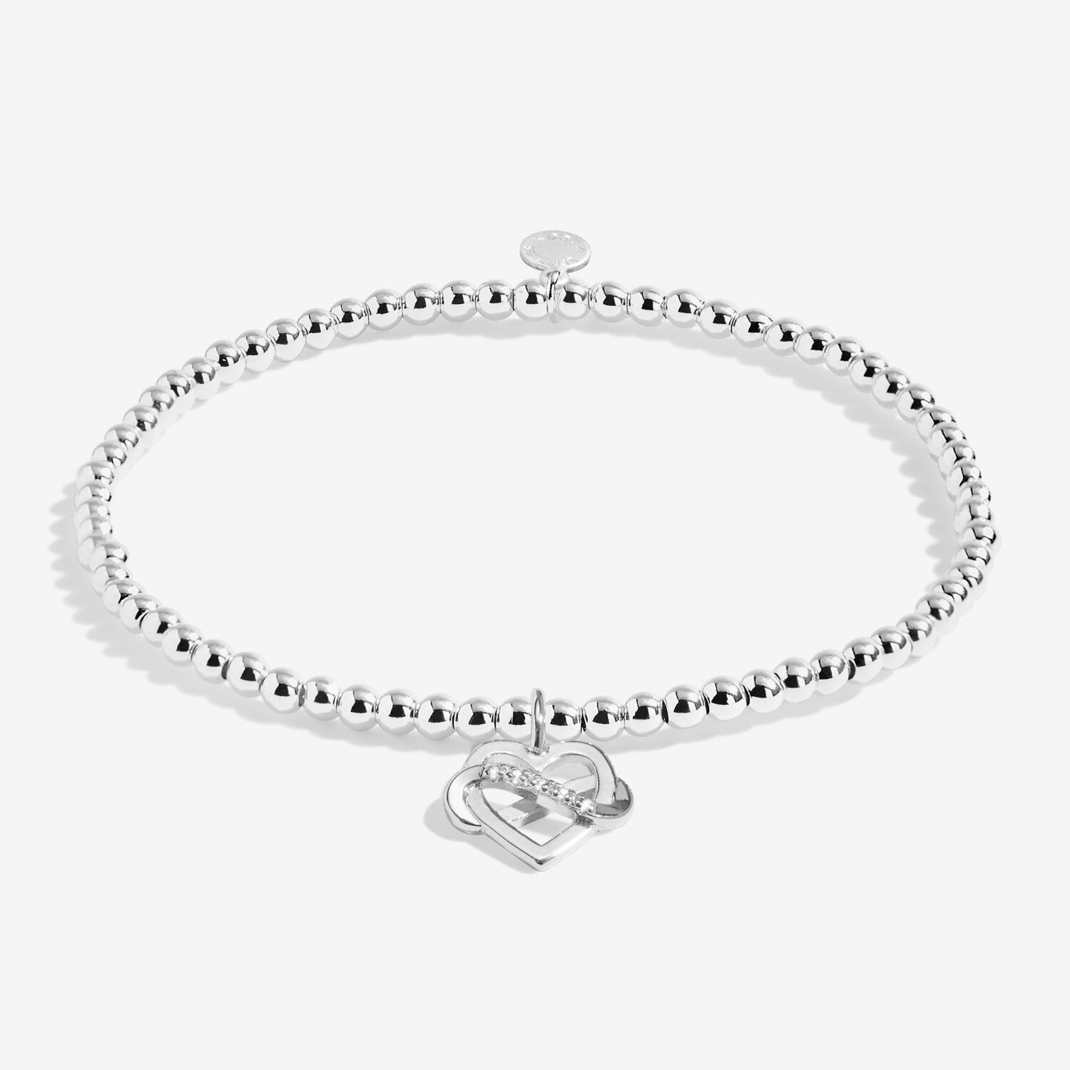 Silver bracelet with a heart-shaped charm on a white background. Available at Be Charmed