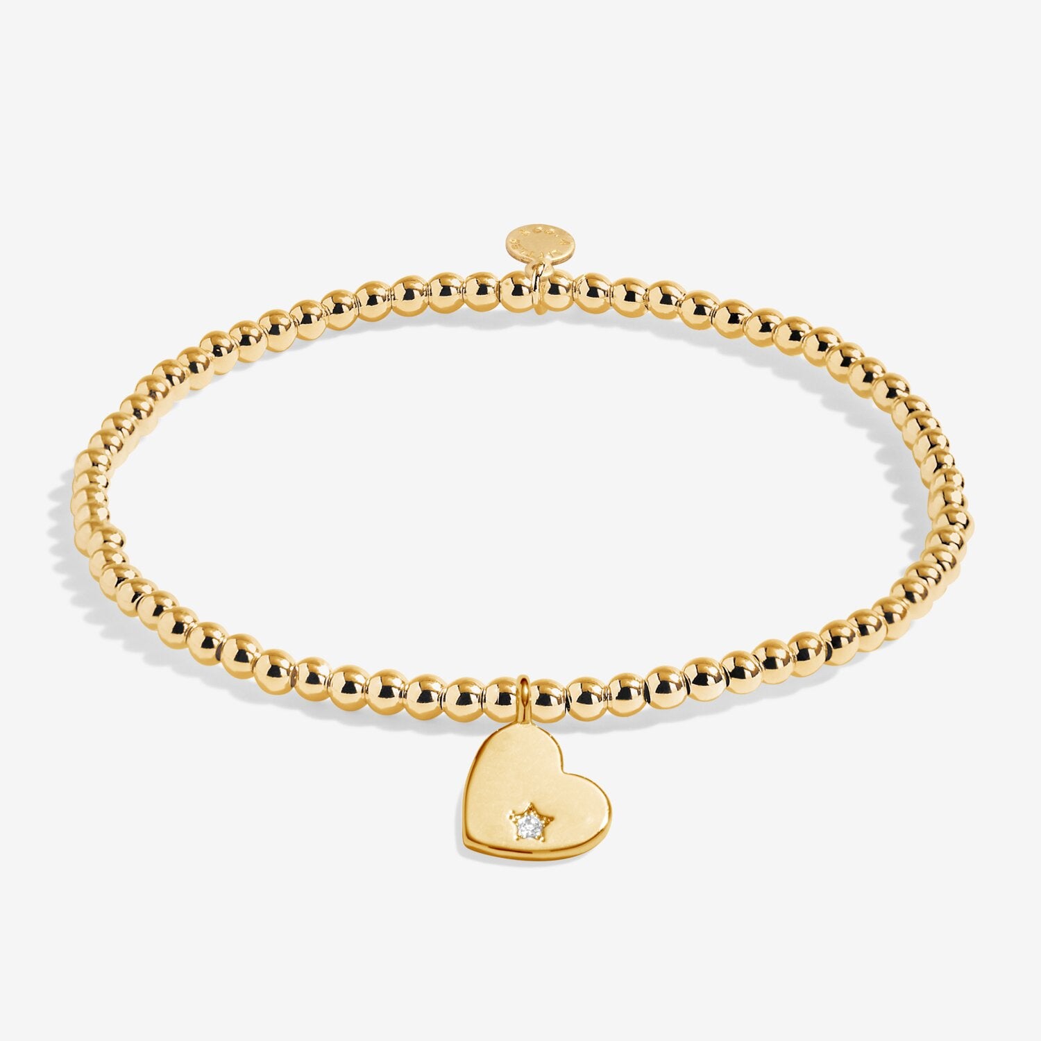 Gold bracelet with a heart-shaped charm on a white background. Available at Be Charmed