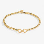 Gold A littles Co friendship bracelet with a clasp on a white background. Available at Be Charmed