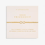 Gold bracelet on a 'Forever Friendship' card with 'A Littles & Co.' branding. Available at Be Charmed