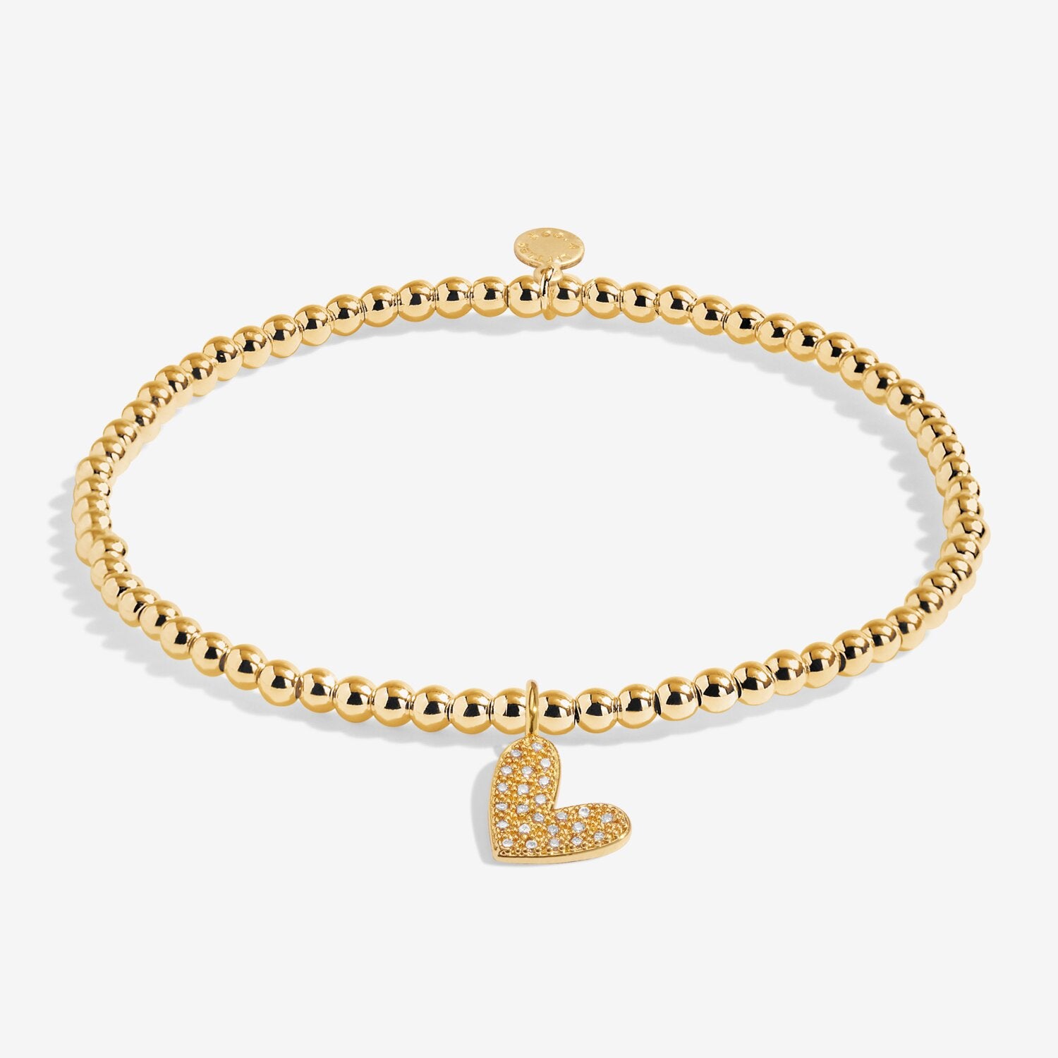 Gold bracelet with a heart charm on a white background. Available at Be Charmed