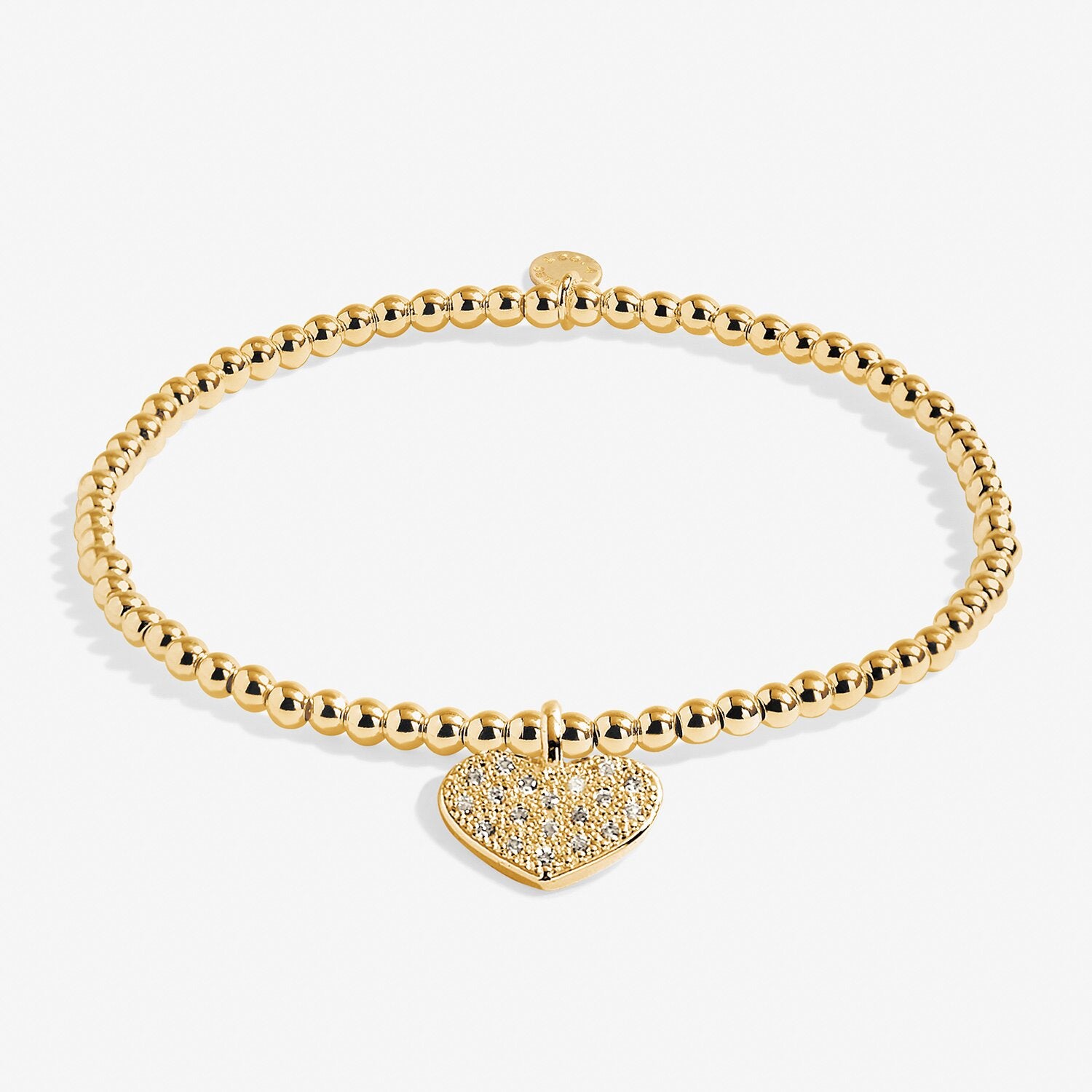 Gold bracelet with a heart-shaped charm on a white background. Available at Be Charmed