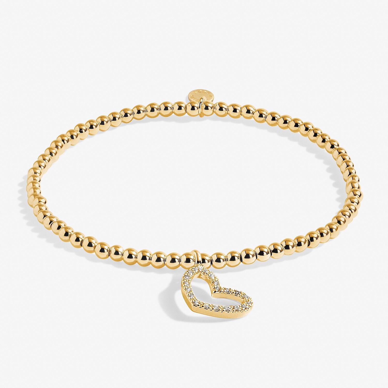 Gold bracelet with a heart-shaped charm on a white background. Available at Be Charmed