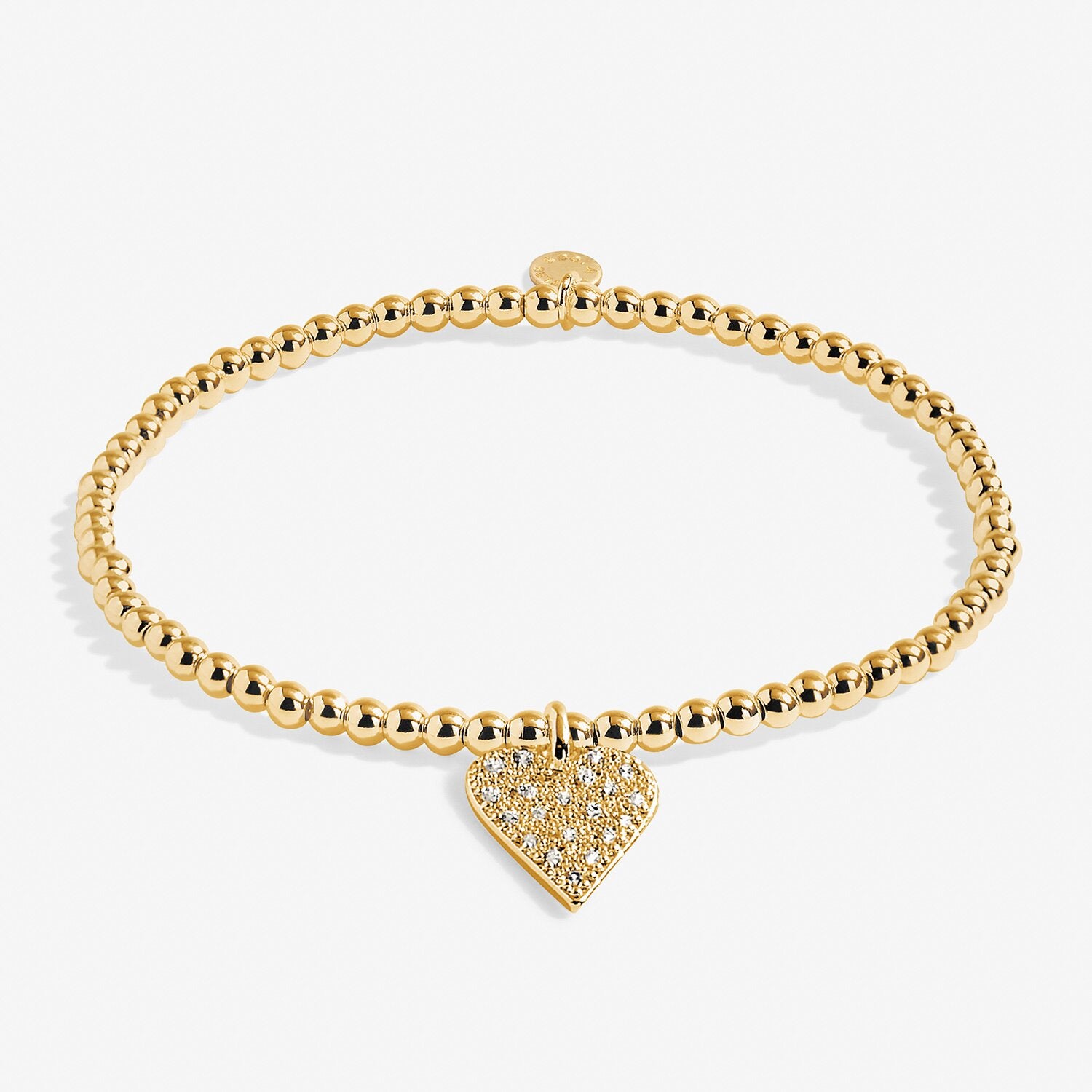 Gold bracelet with a heart-shaped charm on a white background. Available at Be Charmed