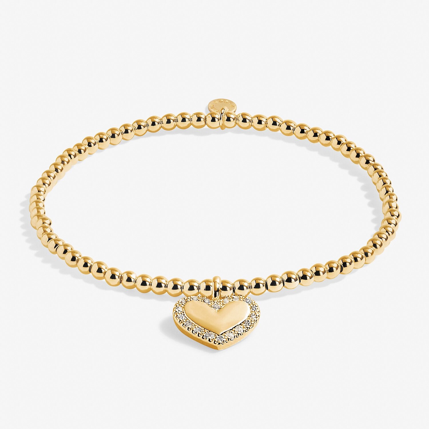 Gold bracelet with a heart-shaped charm on a white background.  Available at Be Charmed