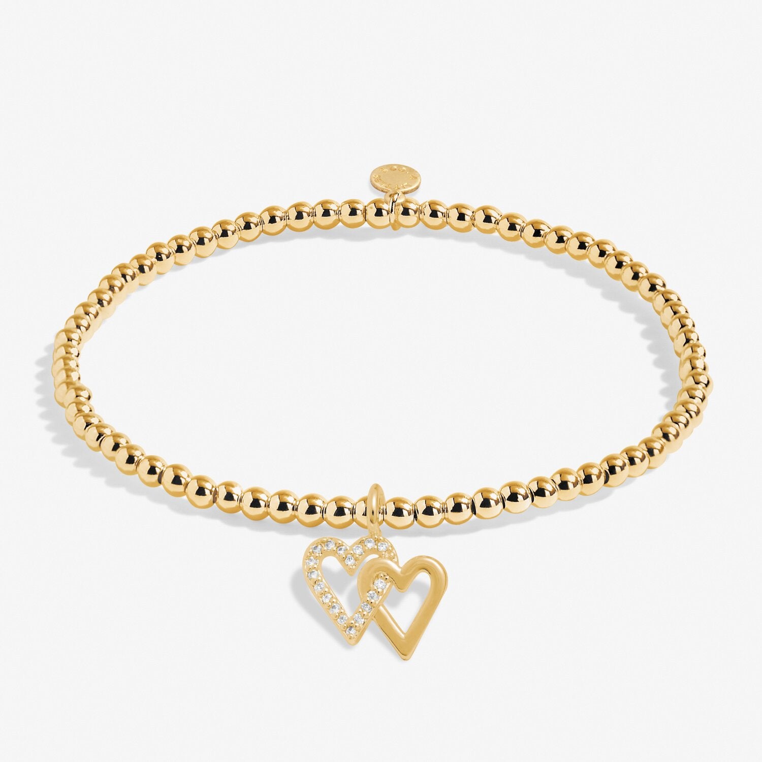 Gold bracelet with a heart charm on a white background. Available at Be Charmed