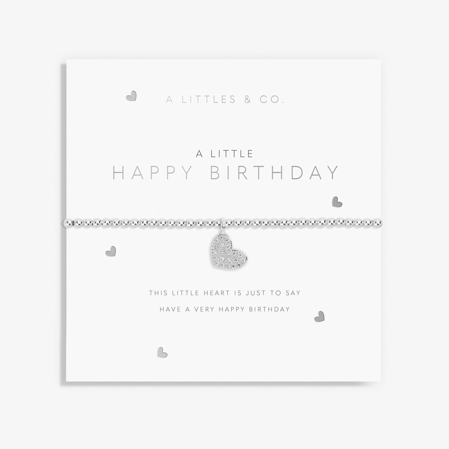 Silver heart-shaped bracelet on a white card with 'A Littles & Co' branding. Available at Be Charmed 