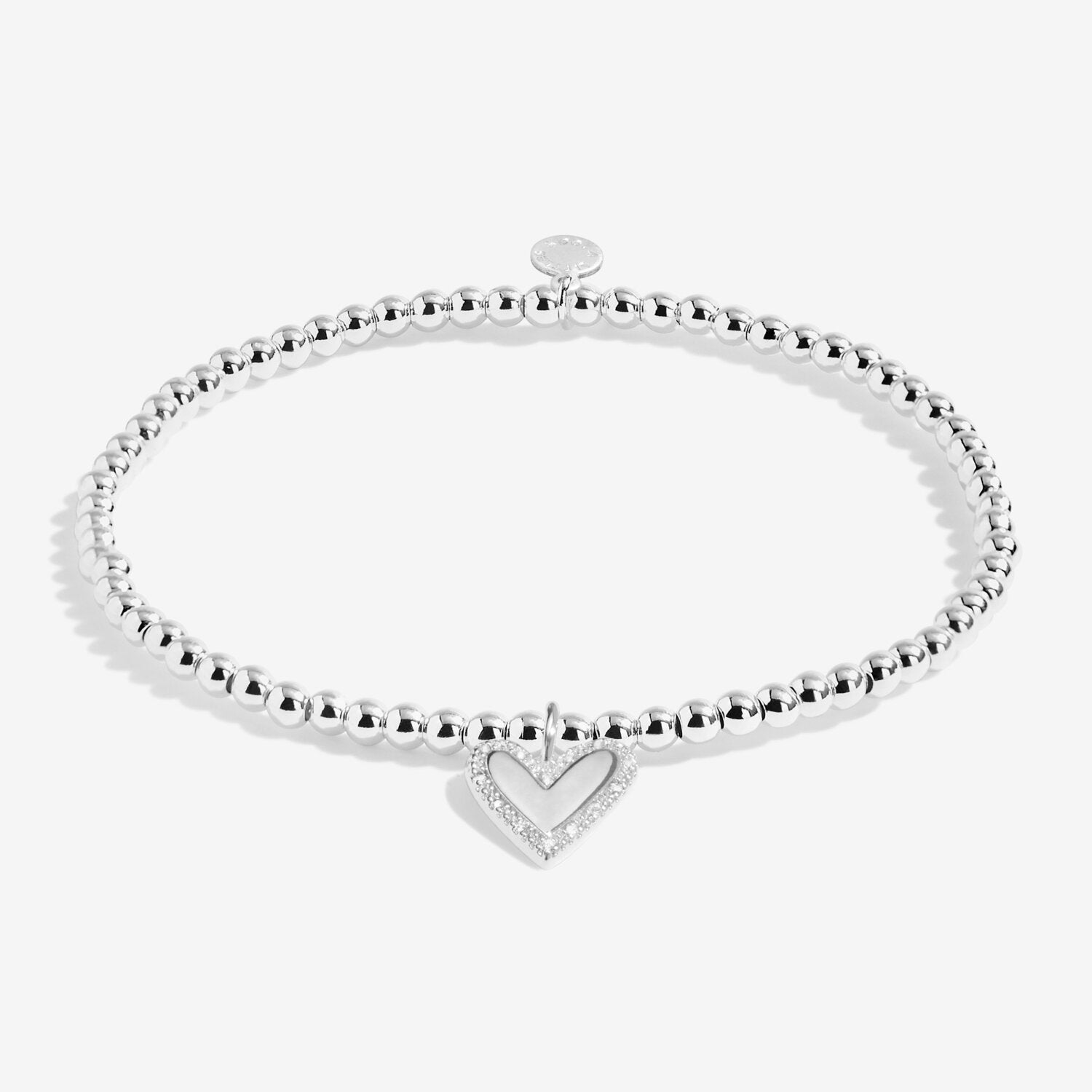 Silver bracelet with a heart charm on a white background. Available at Be Charmed
