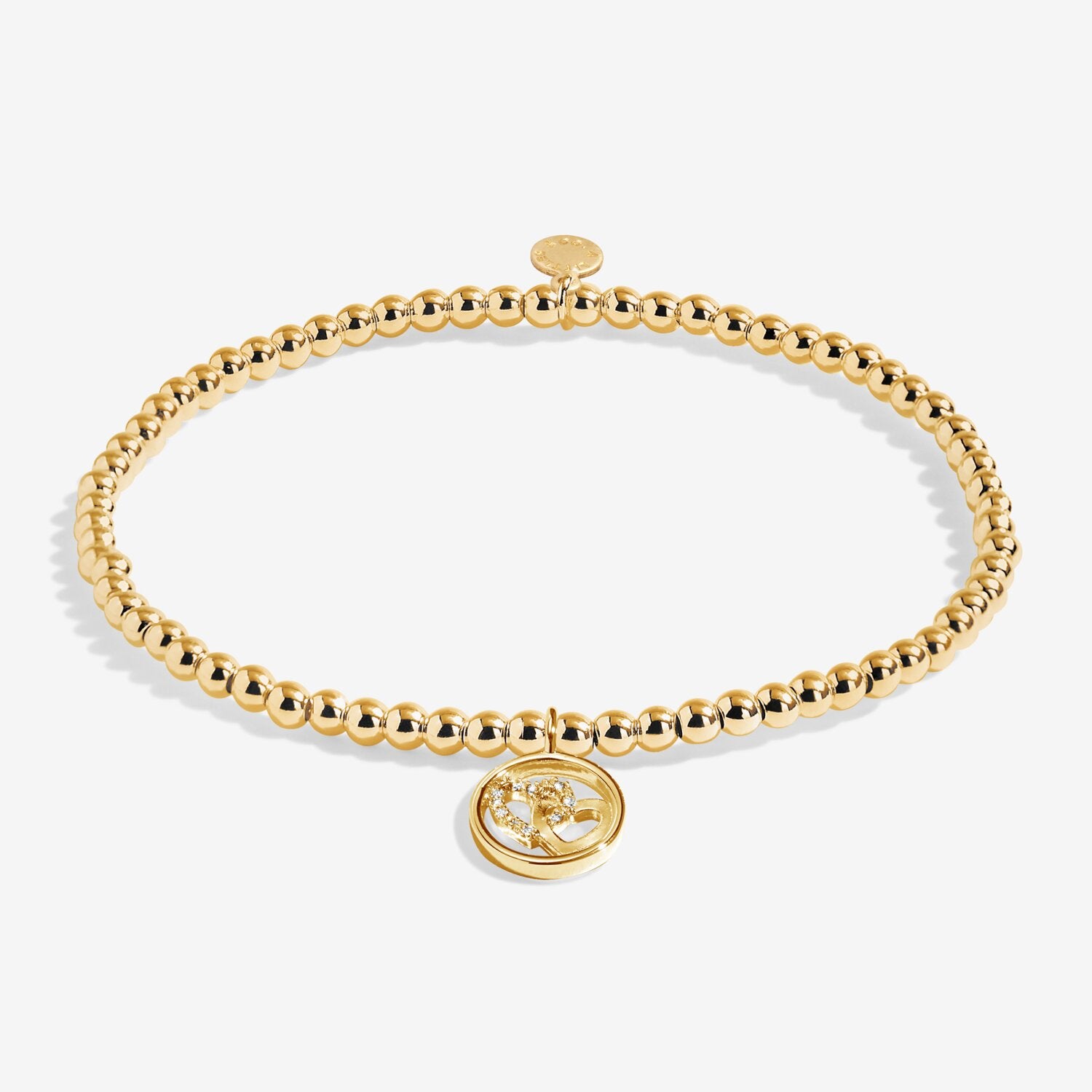 Gold beaded bracelet with a round charm on a white background. Available at Be Charmed
