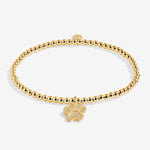Gold bracelet with a paw charm on a white background. Available at Be Charmed