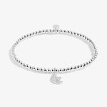 Silver beaded bracelet with a moon and star charm on a white background. Available at Be Charmed