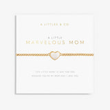 A gold-colored bracelet with a white heart-shaped charm, labeled 'A Littles & Co Marvelous Mom' on a white background. Available at Be Charmed