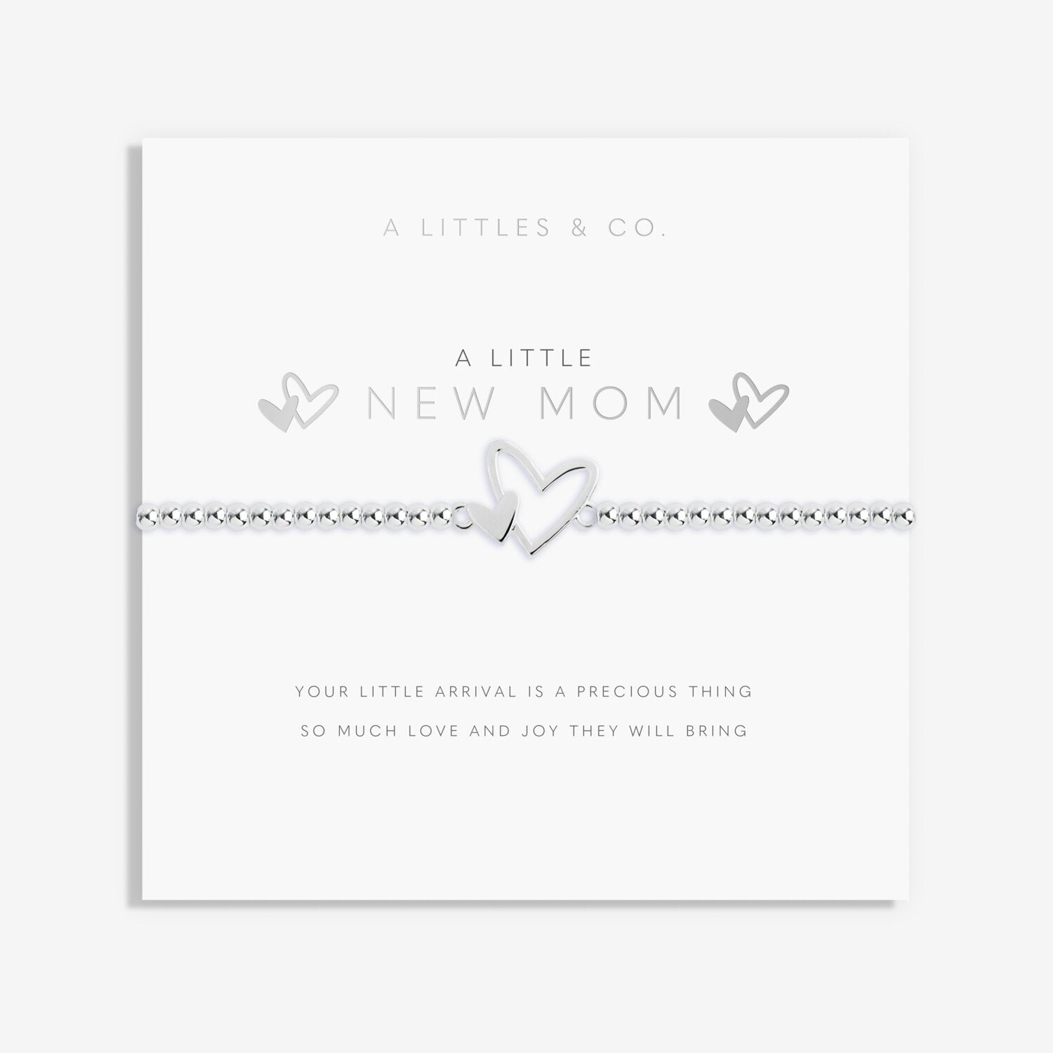 Silver bracelet with heart design on a white card with text, featuring 'A Littles & Co' branding. Available at Be Charmed