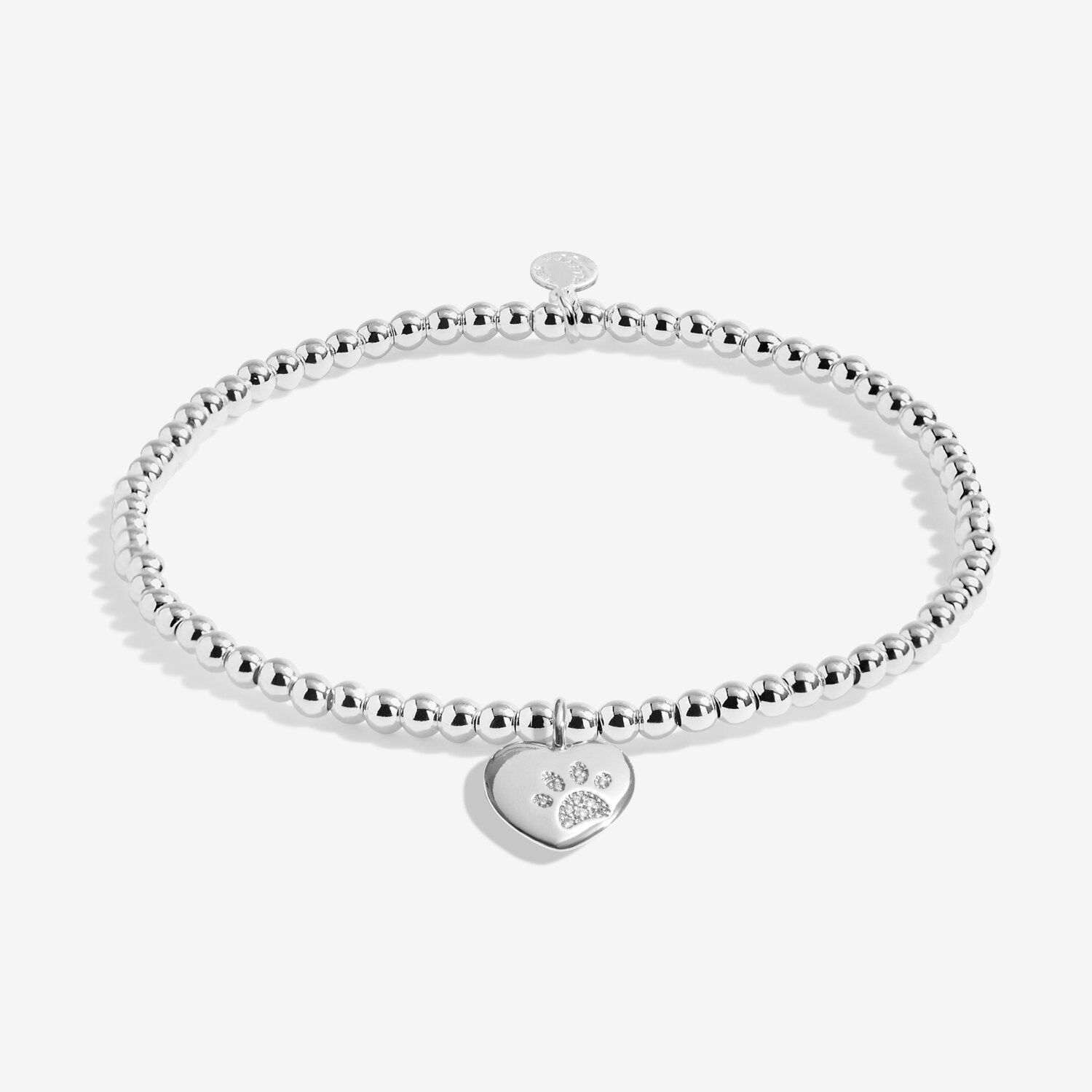 Silver bracelet with a heart-shaped tag on a white background. Availabe at Be Charmed