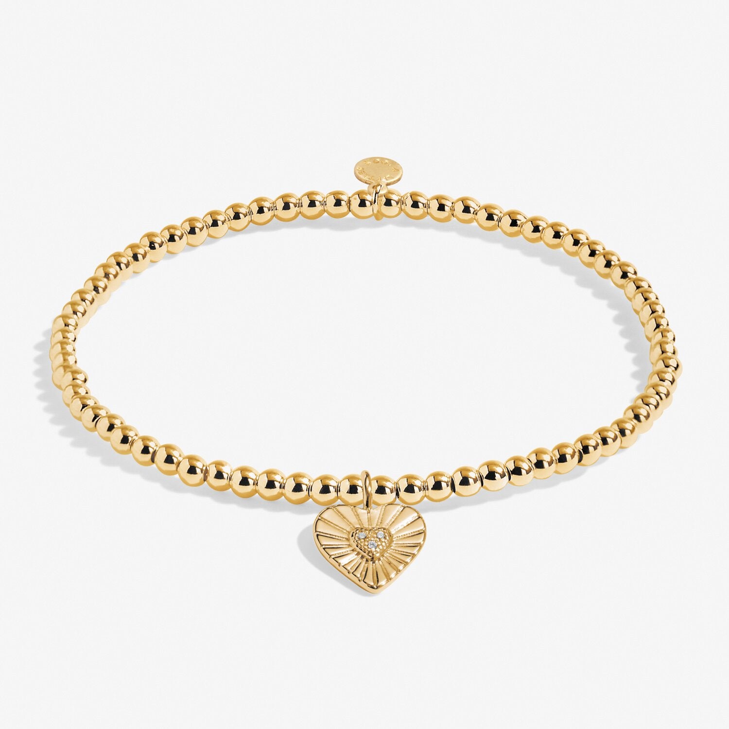 Gold bracelet with a heart-shaped charm on a white background. Available at Be Charmed