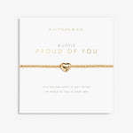 Gold bracelet with heart charm on a 'A Littles & Co.' card. Available at Be Charmed