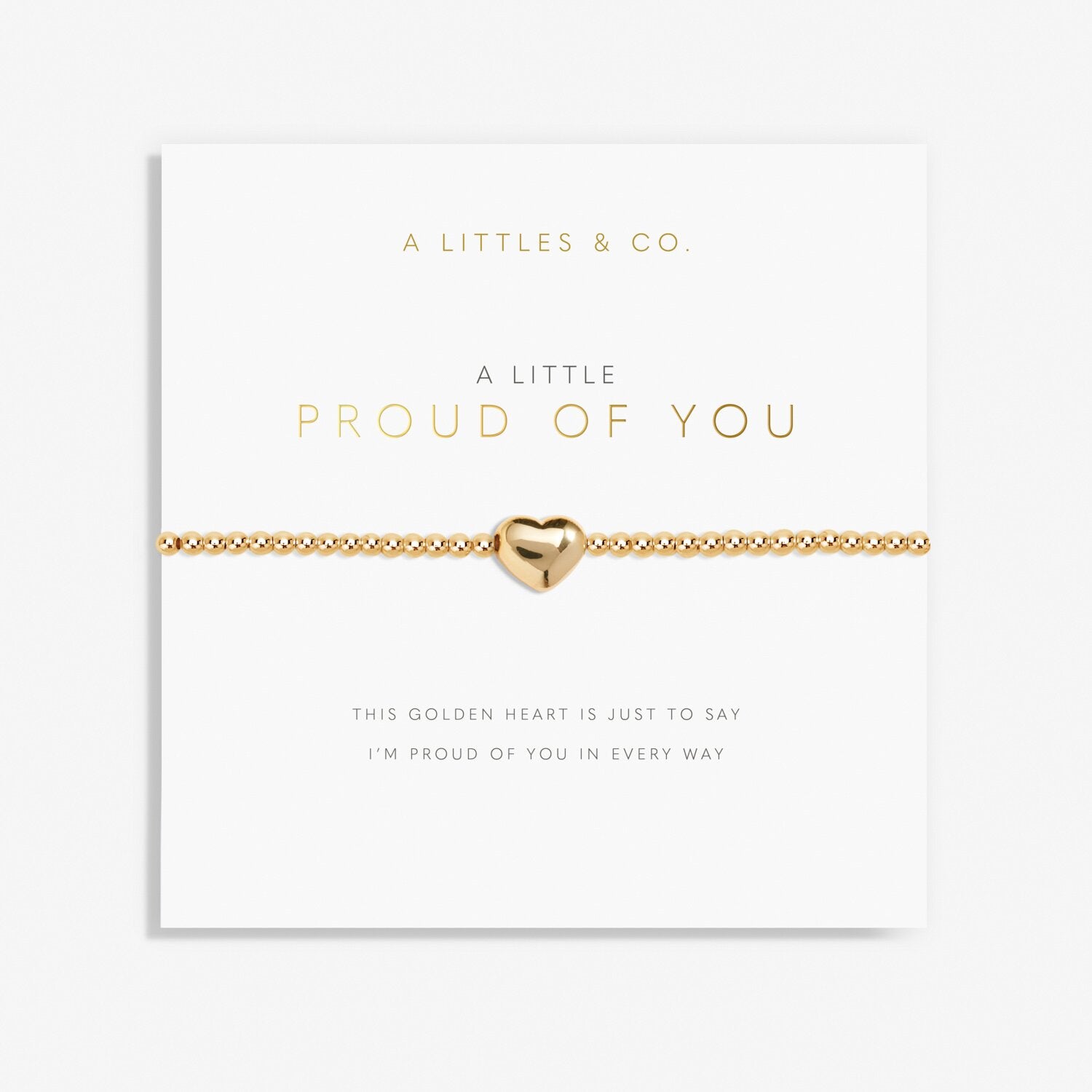 Gold bracelet with heart charm on a 'A Littles & Co.' card. Available at Be Charmed