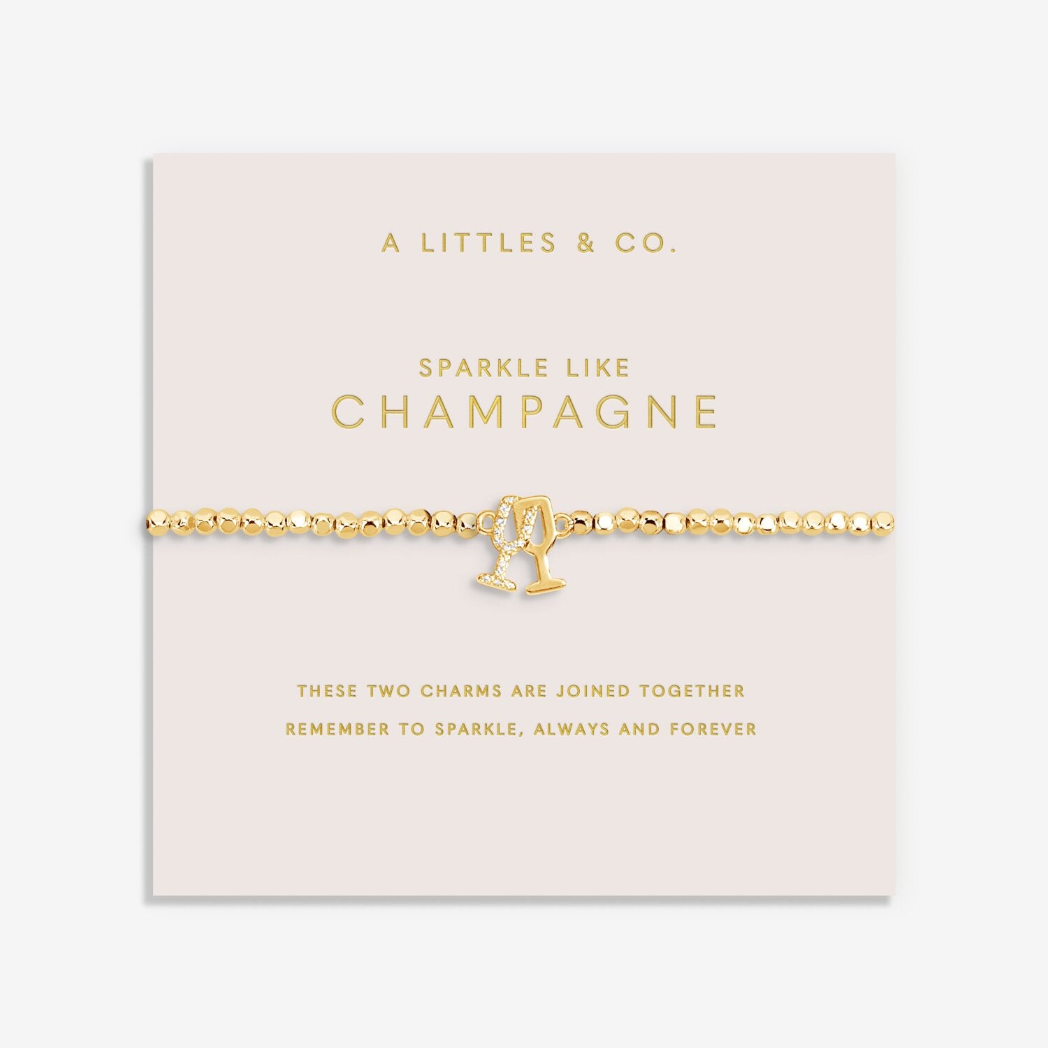 A Littles & Co Gold bracelet with champagne glass charm on a pink card with text. Available at Be Charmed