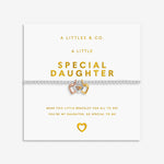 Bracelet with heart charm on a white card with gold text, featuring 'A Littles & Co.' branding. Available at be Charmed