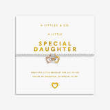 Bracelet with heart charm on a white card with gold text, featuring 'A Littles & Co.' branding. Available at be Charmed