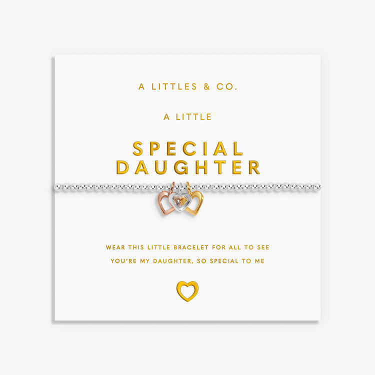 Bracelet with heart charm on a white card with gold text, featuring 'A Littles & Co.' branding. Available at be Charmed